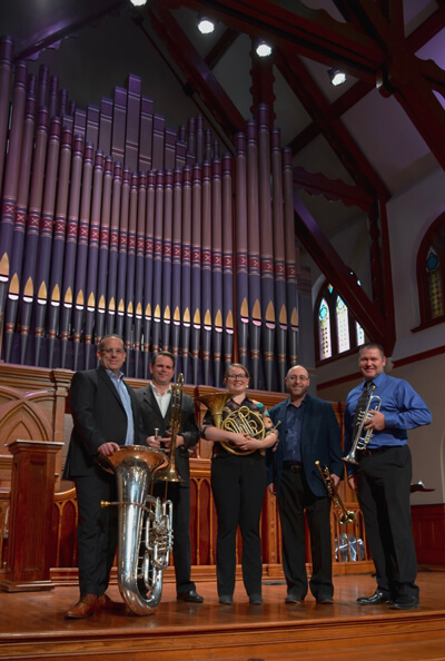 nexus brass in front of organ pipes in church