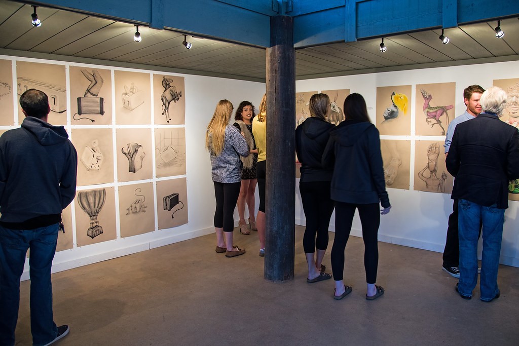 people viewing exhibit of artwork in Heller Gallery