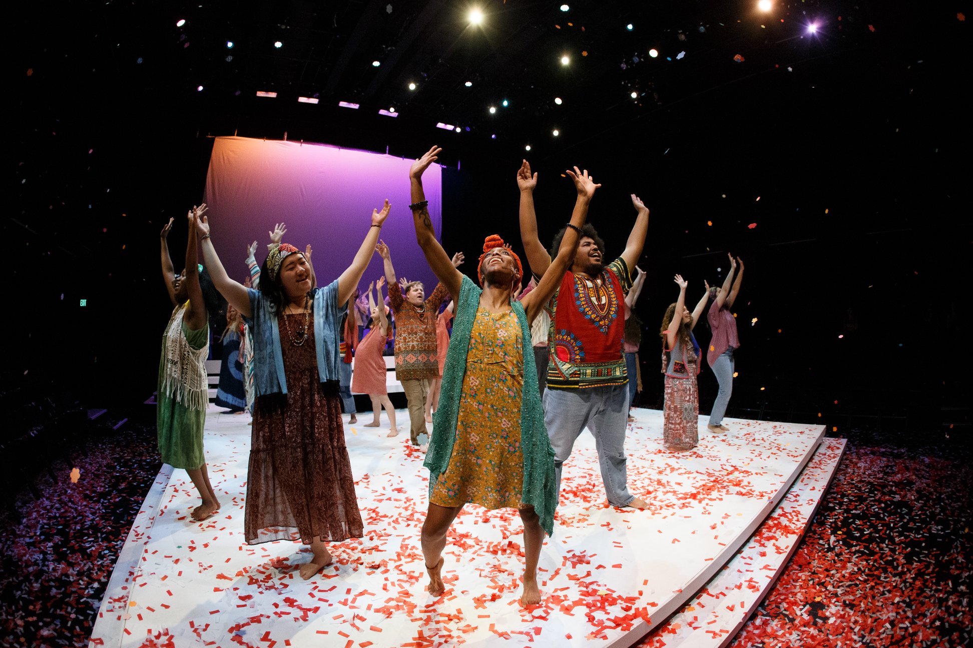 people dancing on stage with confetti