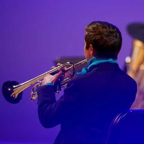 Trumpeter with tuba in background