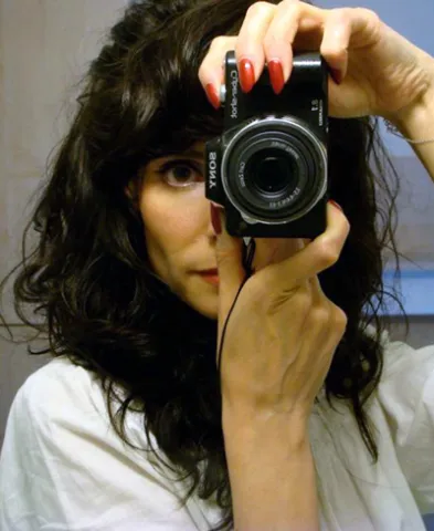 Nadine Boljkovac holding a manual film camera to her eye