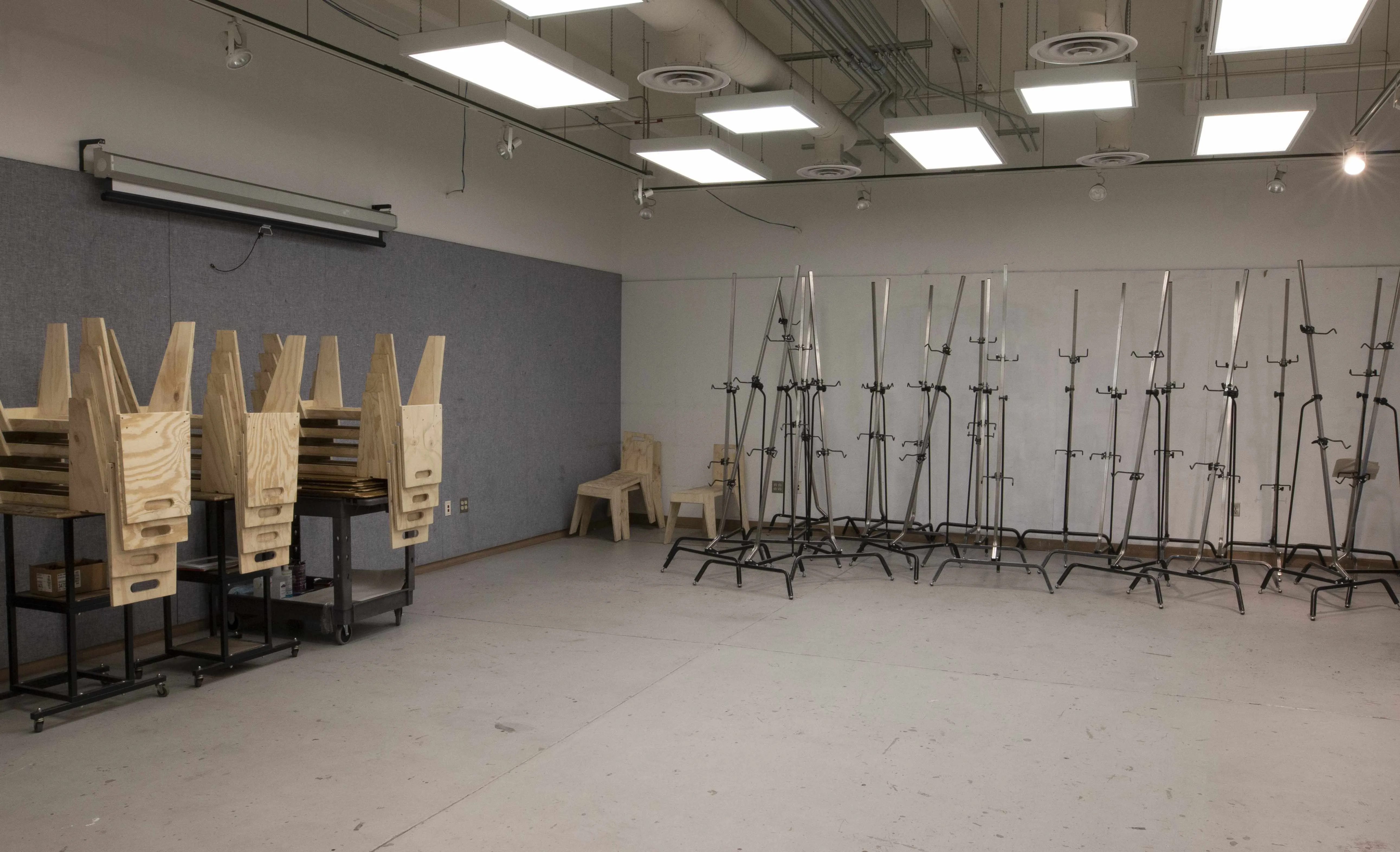 classroom with screen, chairs, easels