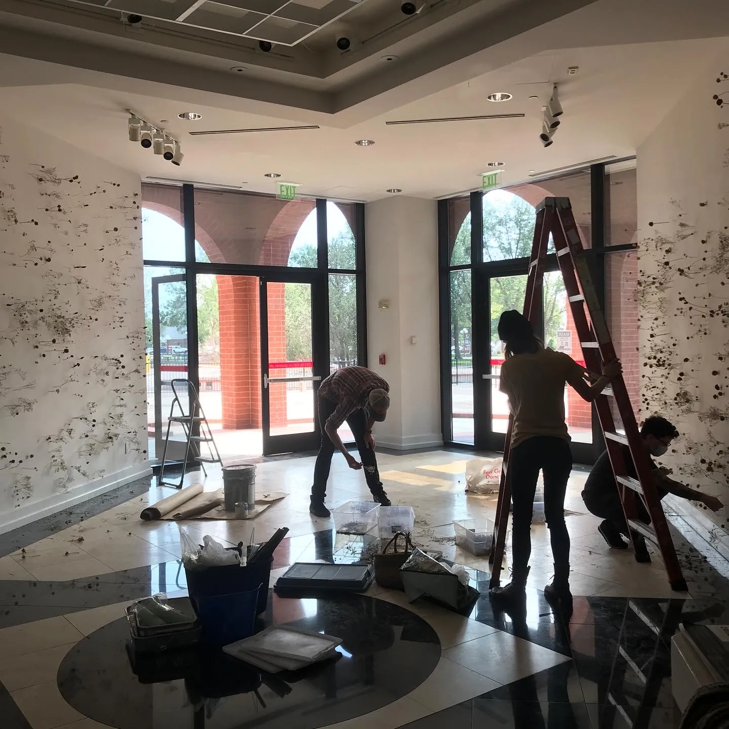 GOCA 121 exhibit space with people installing exhibit