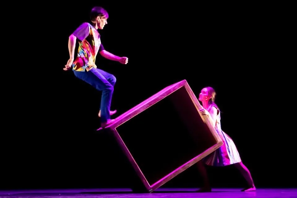 dancers balancing on box