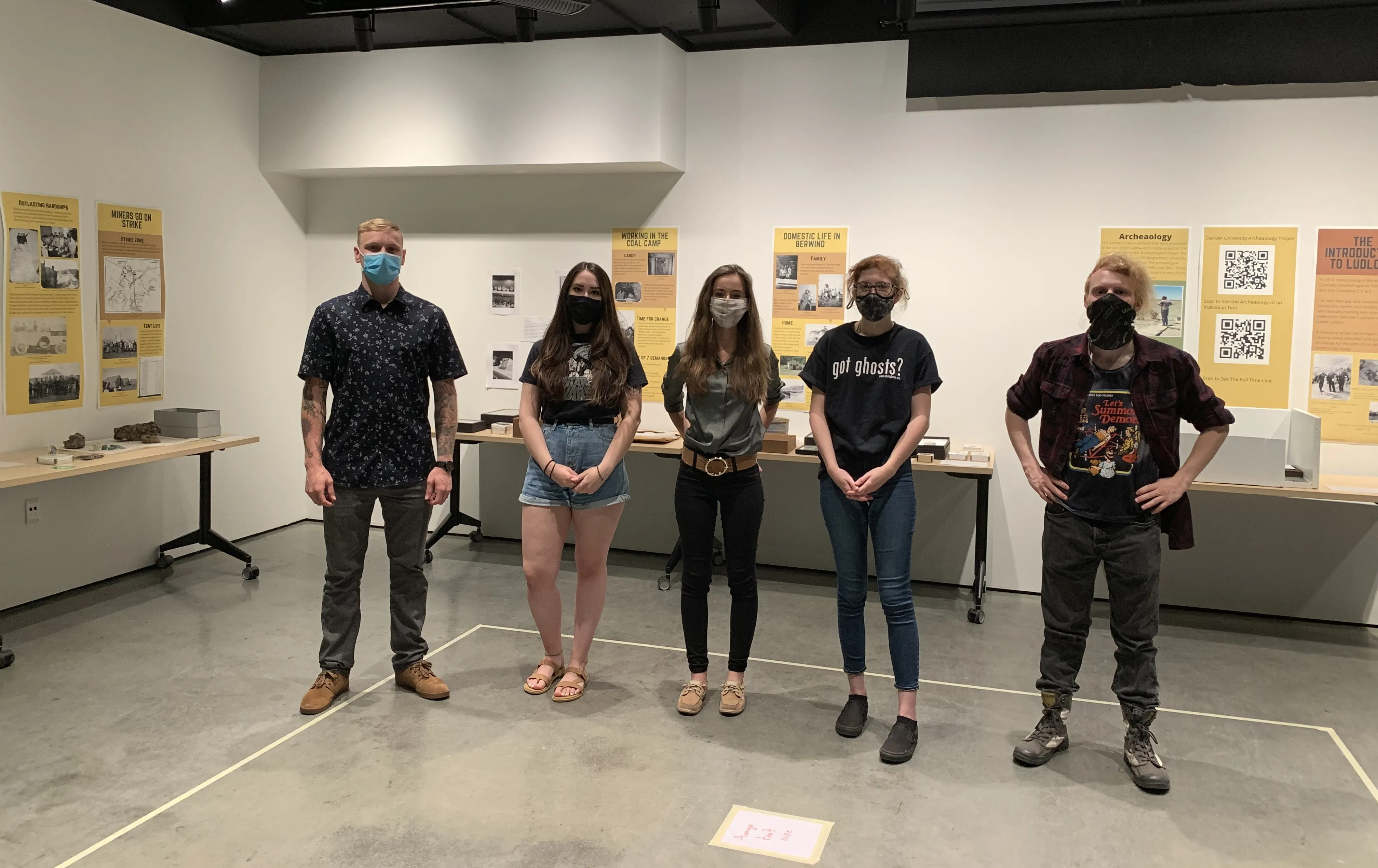 people standing in front of curated exhibit