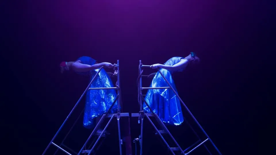 dancers in mood lighting on moving stairs