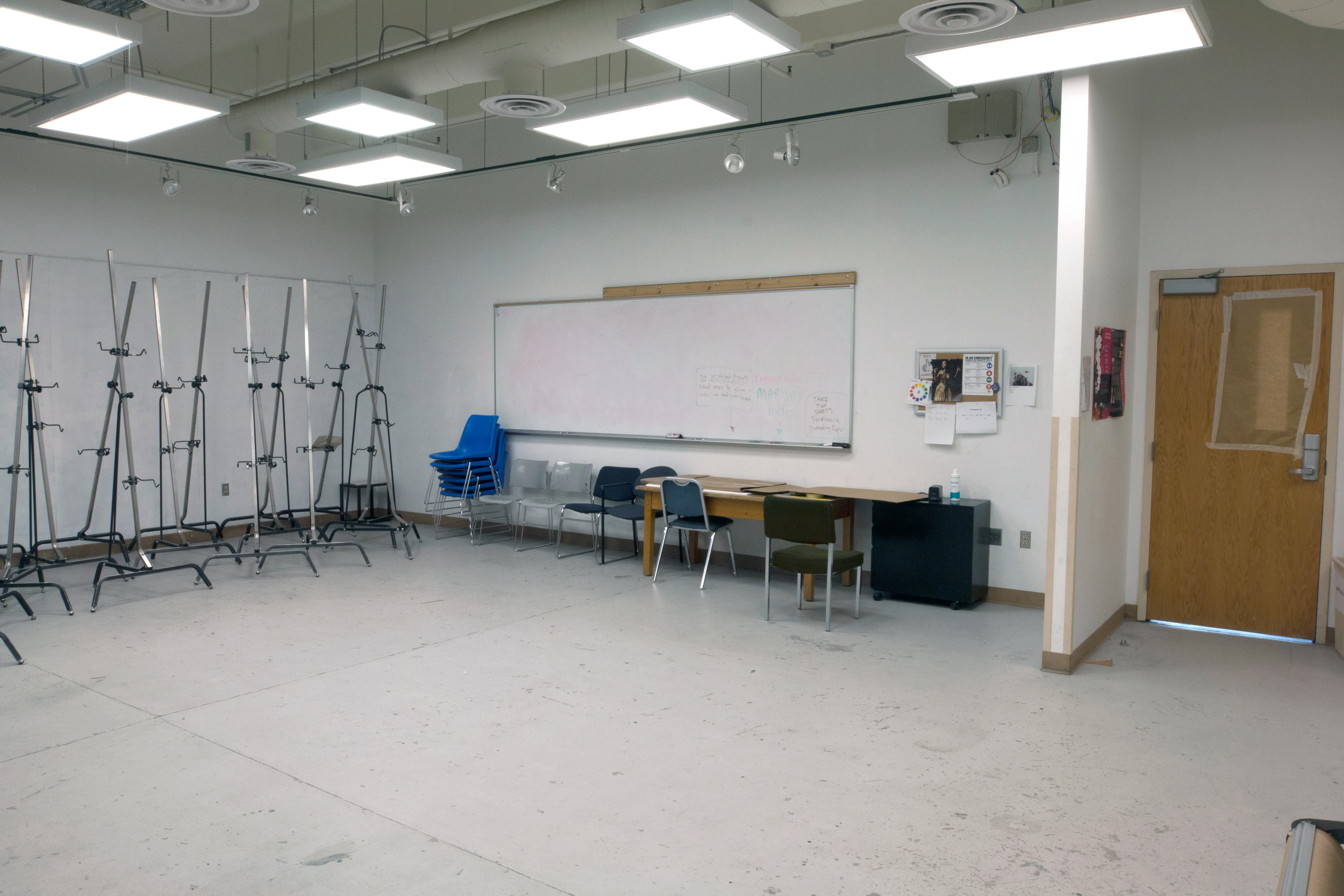 Art classroom with easels and a large dry erase board
