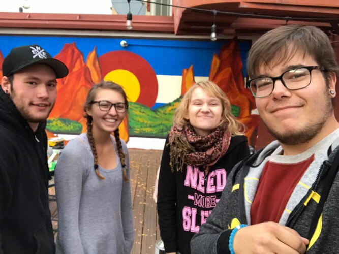 Art club members with mural painted @ The Perk Downtown in fall of 2017